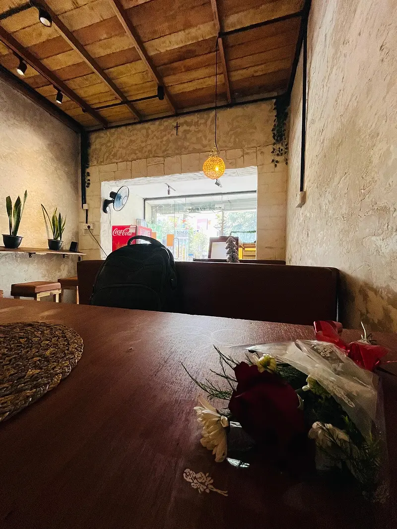 Timber ceiling, plaster walls and a wooden table set by the front window