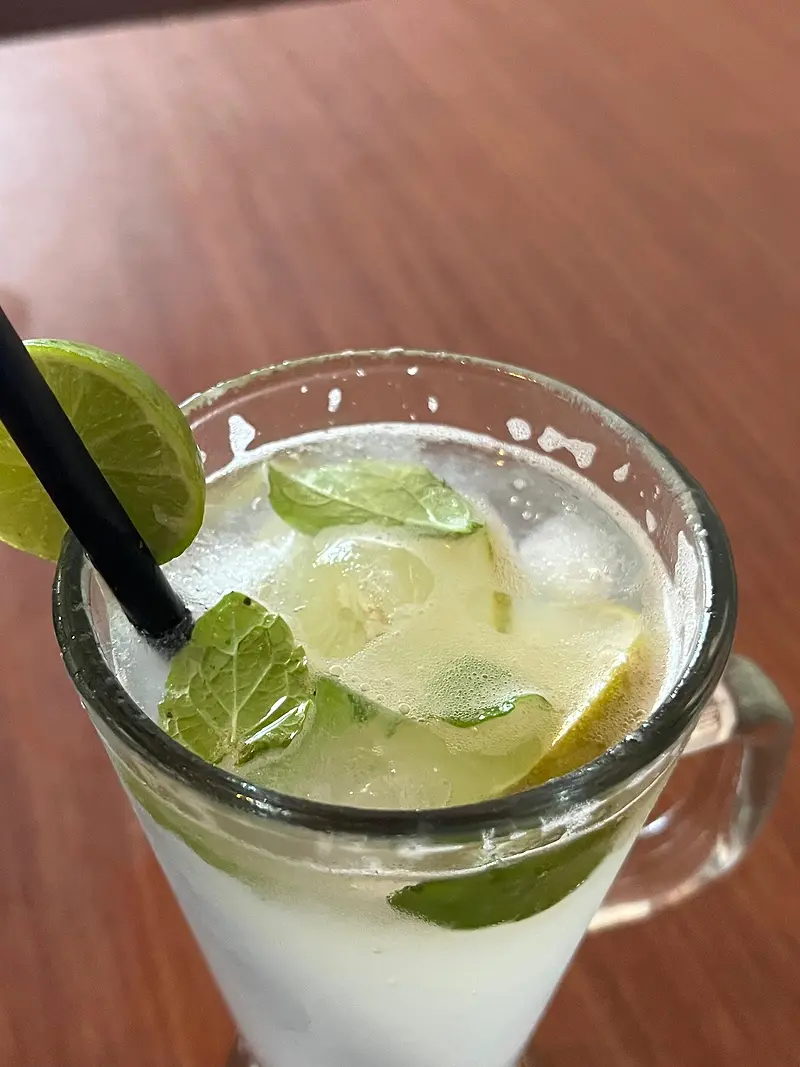 Lime mojito with crushed ice, mint and a straw