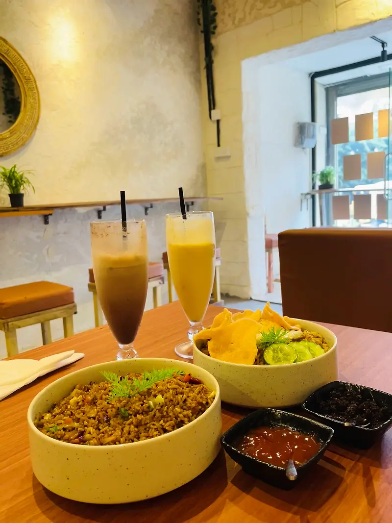Fried rice with prawn crackers and chilli sambal, served with two fresh juices